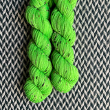 HIGHLIGHTER GREEN -- Half-Skein -- Alphabet City tweed sock yarn (black/grey nep) -- ready to ship