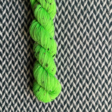 HIGHLIGHTER GREEN -- Half-Skein -- Alphabet City tweed sock yarn (black/grey nep) -- ready to ship