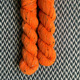 HIGHLIGHTER ORANGE -- Half-Skein -- Alphabet City tweed sock yarn (black/grey nep) -- ready to ship