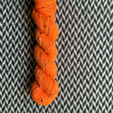 HIGHLIGHTER ORANGE -- Half-Skein -- Alphabet City tweed sock yarn (black/grey nep) -- ready to ship