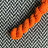 HIGHLIGHTER ORANGE -- Half-Skein -- Alphabet City tweed sock yarn (black/grey nep) -- ready to ship